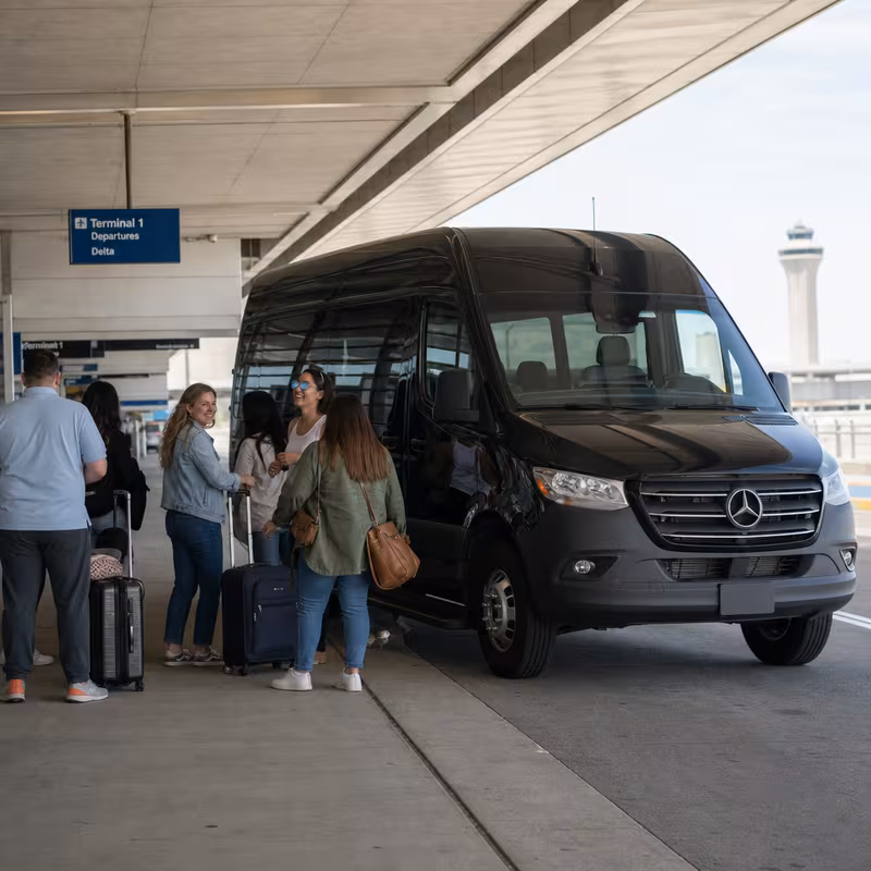 Group boarding a white charter bus for Airport Transportation transportation in St. Louis