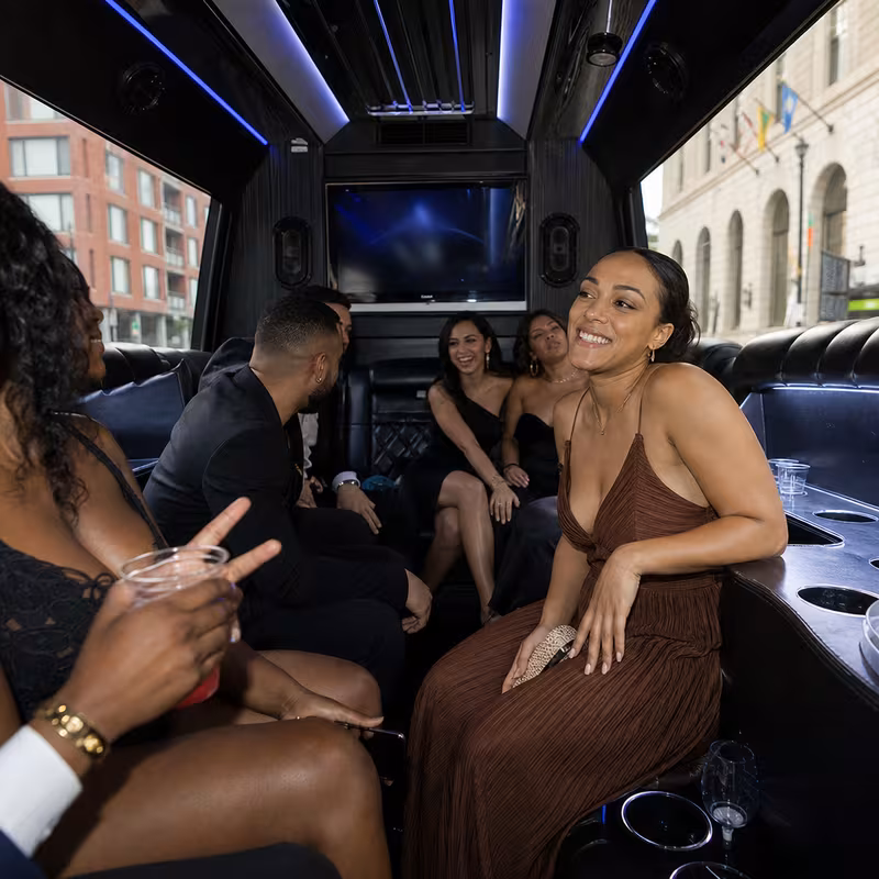 Party bus interior with wraparound leather seating and LED lighting in St. Louis