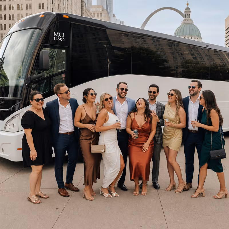 Passengers loading luggage while boarding an St. Louis group shuttle