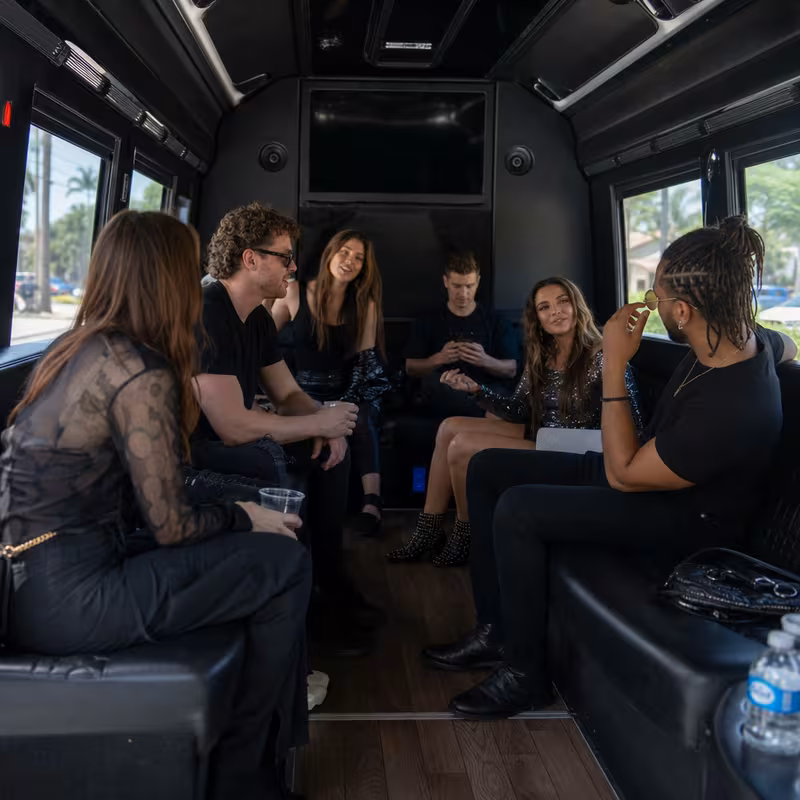 Group boarding a white charter bus for Concert Transportation transportation in St. Louis