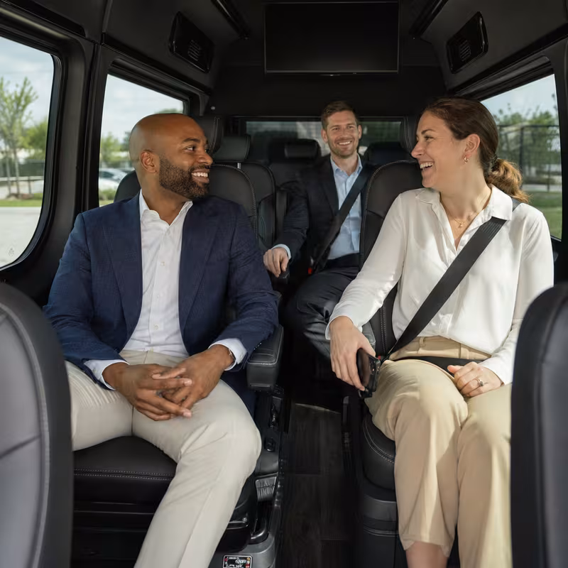 Group boarding a white charter bus for Corporate Transportation transportation in St. Louis