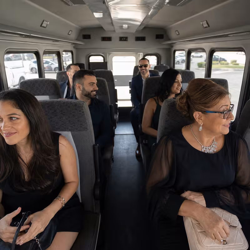 Group boarding a white charter bus for Private Event Transportation transportation in St. Louis