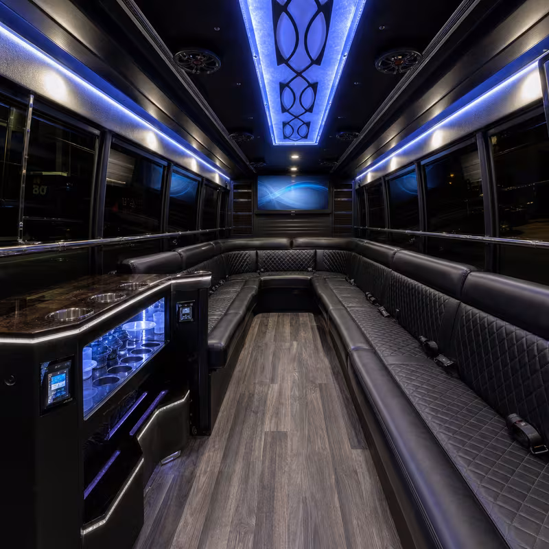 Party bus interior with wraparound leather seating and LED lighting in St. Louis