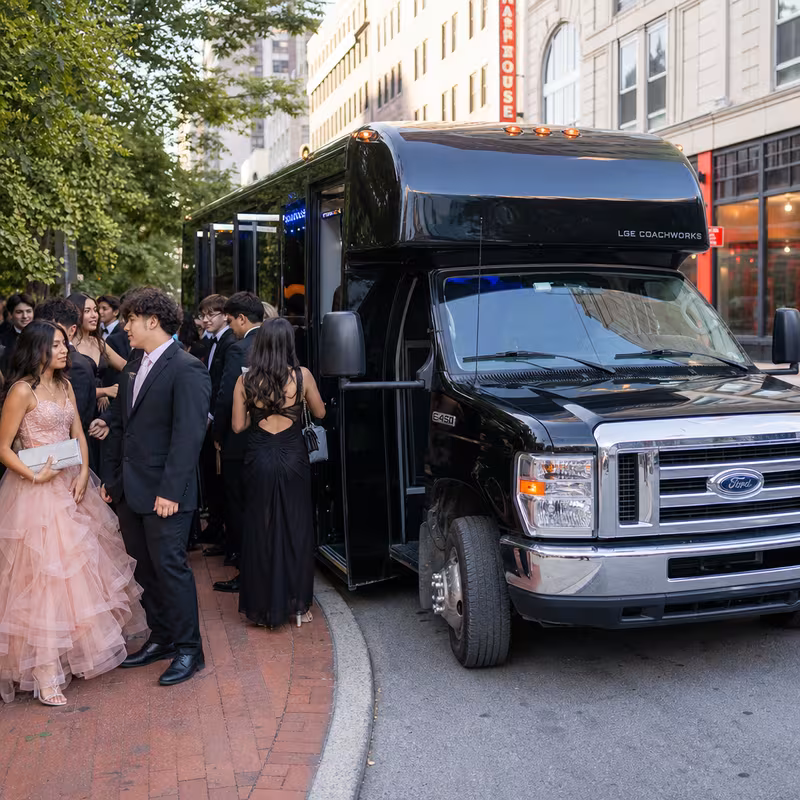 Passengers loading luggage while boarding an St. Louis group shuttle