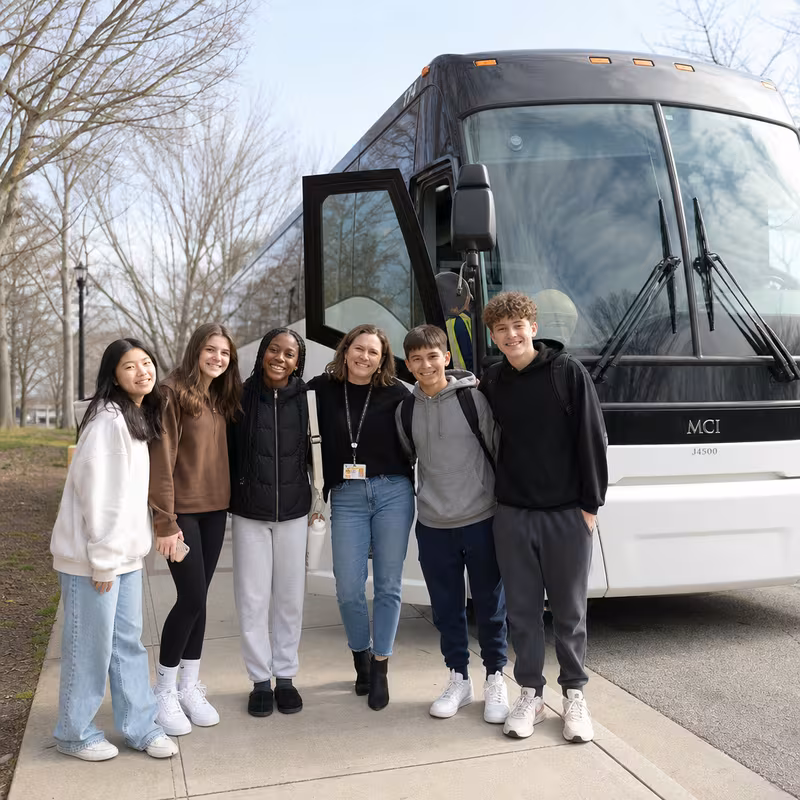 Passengers loading luggage while boarding an St. Louis group shuttle
