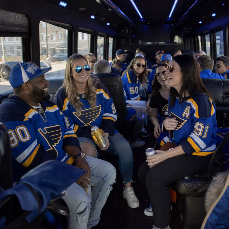 Group boarding a white charter bus for Sporting Event Transportation transportation in St. Louis