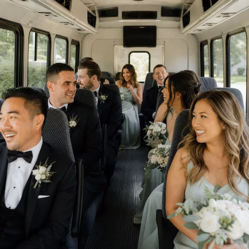 Group boarding a white charter bus for Wedding Transportation transportation in St. Louis