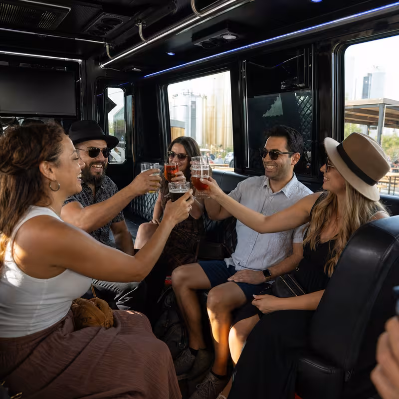 Group boarding a white charter bus for Winery & Brewery Tour Transportation transportation in St. Louis