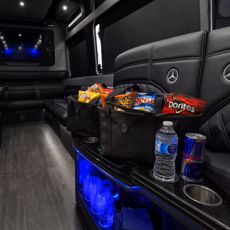 Party bus interior with wraparound leather seating and LED lighting in St. Louis